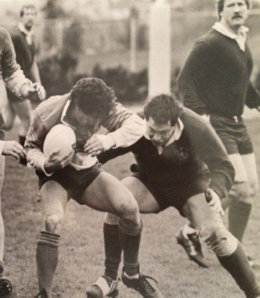 A black and white photo of a group of men playing rugby