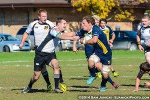 A group of men are playing rugby on a field