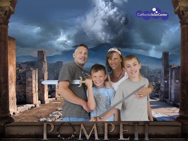 A family posing for a picture in front of a sign that says pompeii