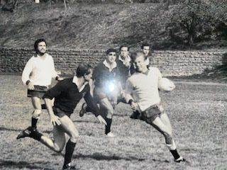 A group of men are playing rugby on a field.