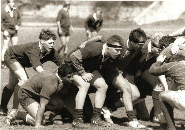 A black and white photo of a group of men playing rugby