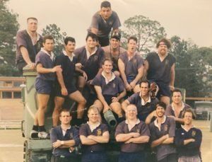 A group of men are posing for a picture with their arms crossed