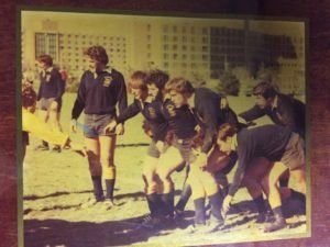 A group of people are standing in a line on a field