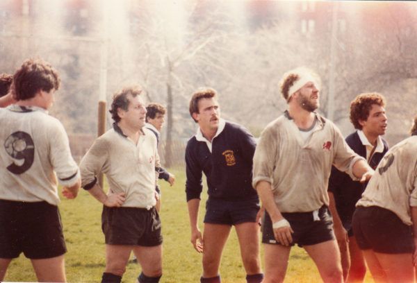 A group of men are standing on a field and one has the number 9 on his back
