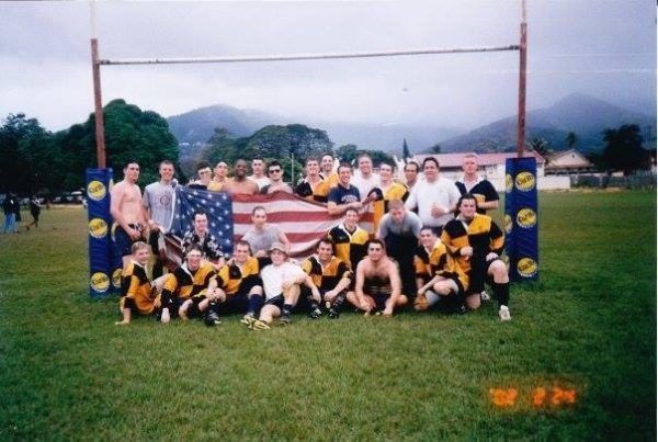 A group of people posing for a picture with an american flag