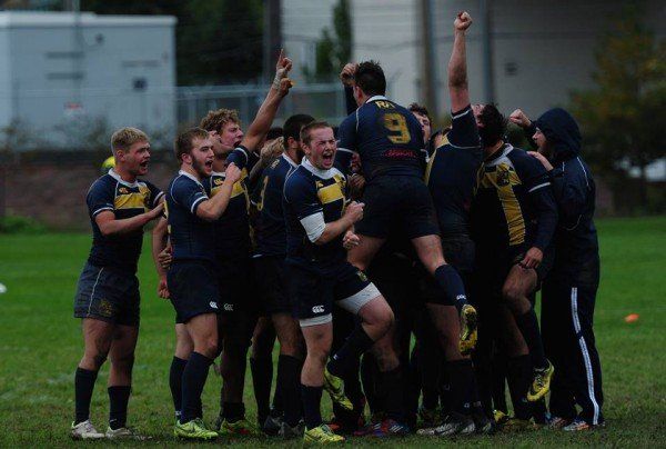 A group of rugby players are huddled together and one of them has the number 9 on his back
