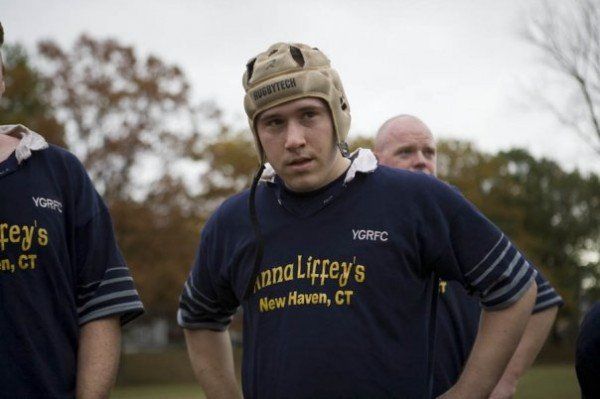 A man wearing a helmet and a shirt that says anna liffey 's new haven ct