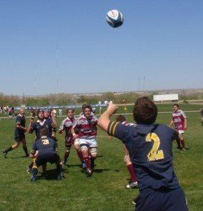 A man with the number 2 on his back is throwing a soccer ball
