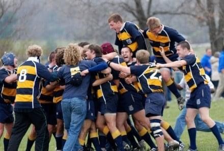 A group of rugby players wearing blue and yellow uniforms with the number 8 on the back