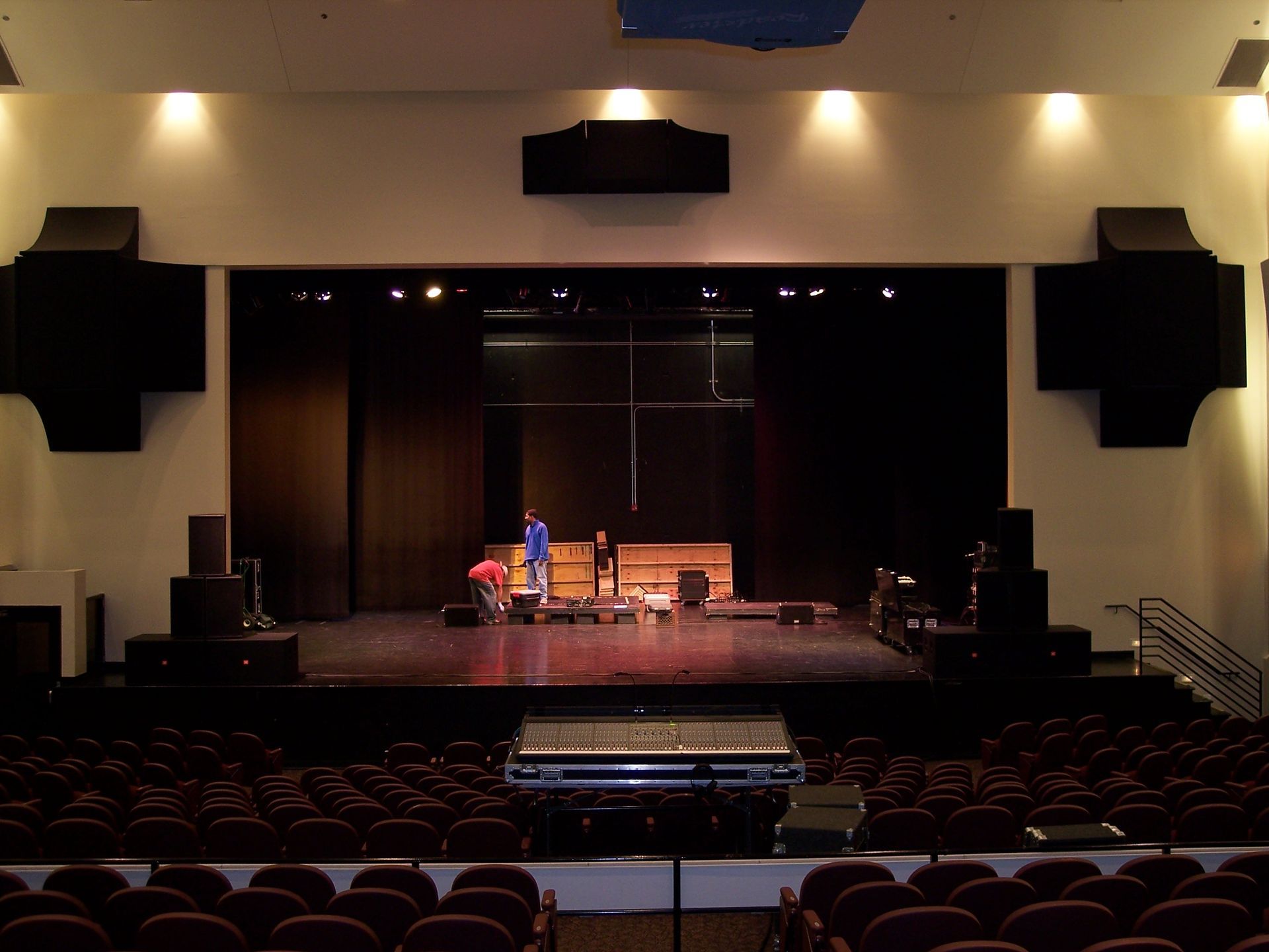 An empty auditorium with a stage and rows of seats