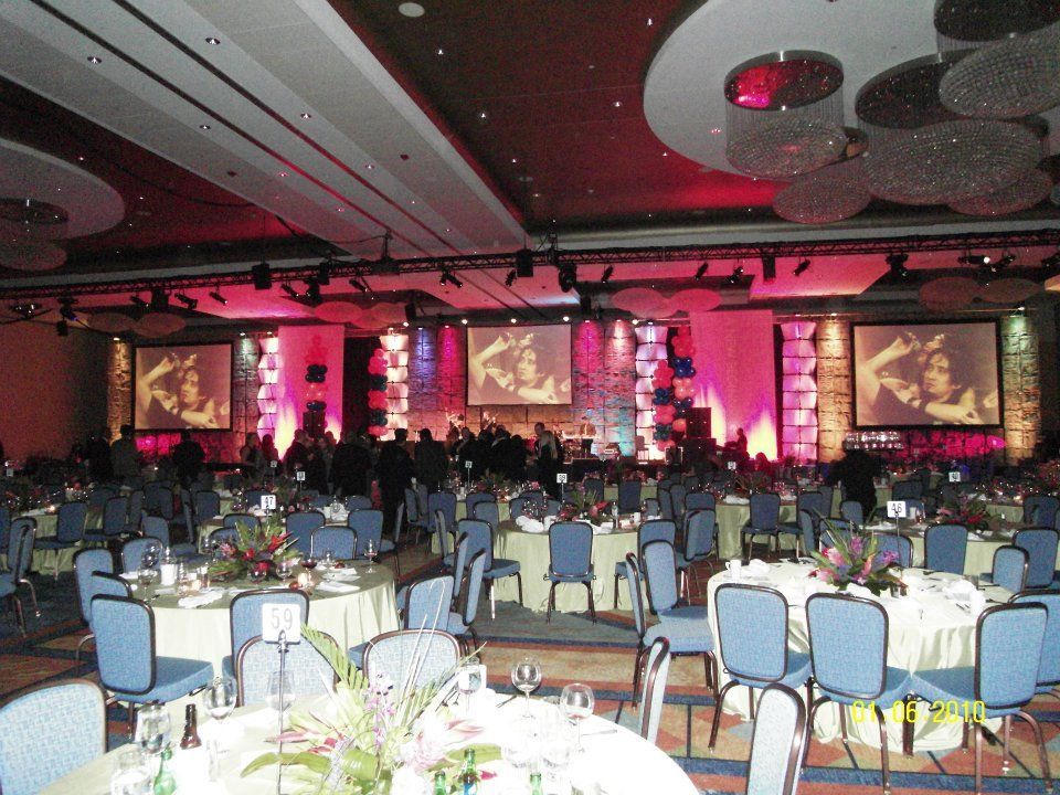 A large room with tables and chairs set up for a banquet