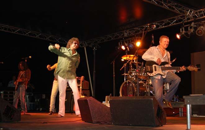 A group of people are playing instruments on a stage.