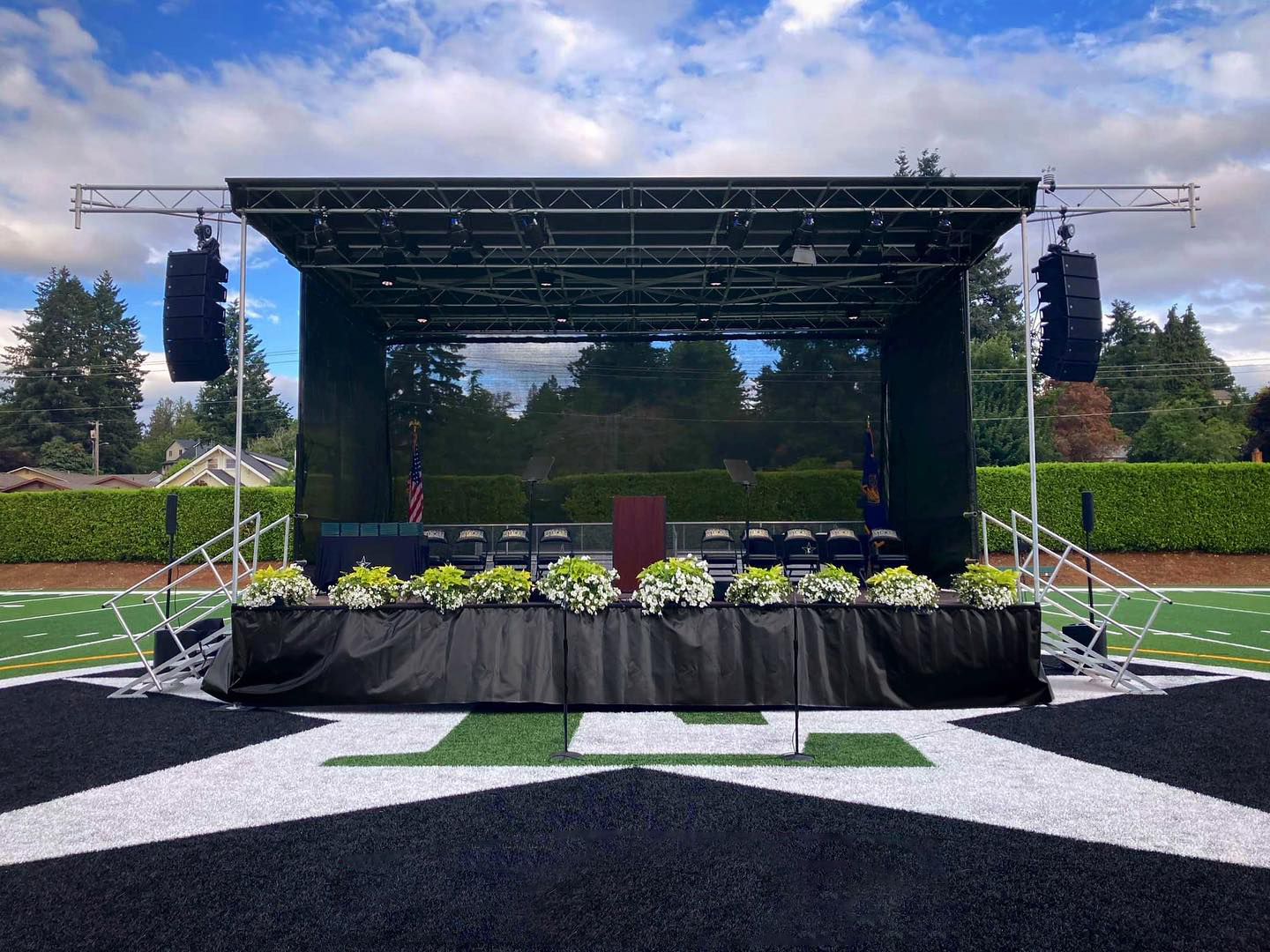 A large stage is sitting on top of a football field.