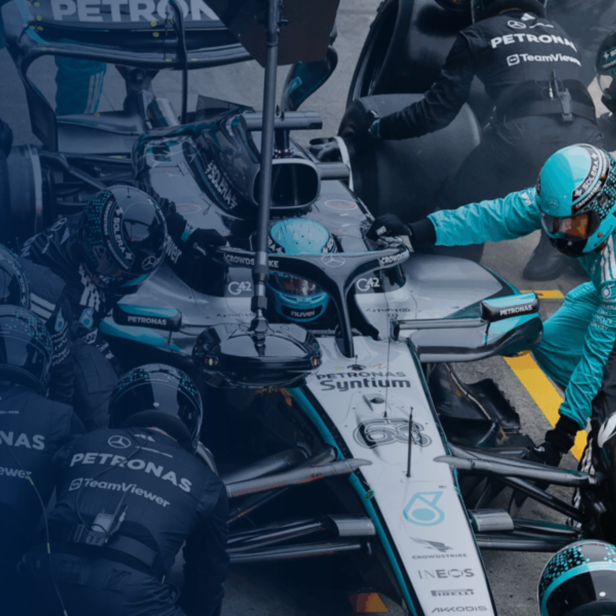 Mercedes-AMG PETRONAS F1 Team car with crew: redefining performance with SAP Cloud ERP.