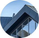A close up of the roof of a building with a blue sky in the background.