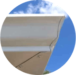 A close up of a roof with a blue sky in the background.