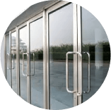 A row of glass doors with stainless steel handles in a circle.
