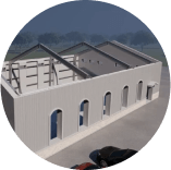 An aerial view of a building with a car parked in front of it.