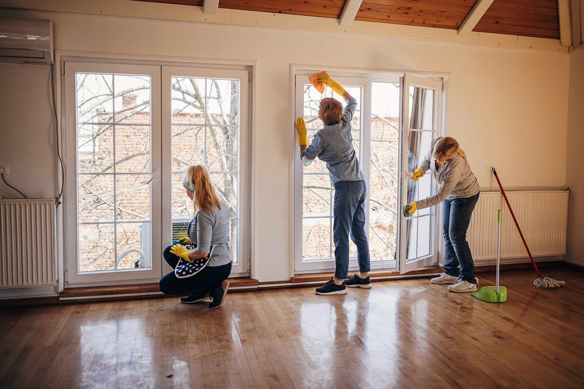 Women Cleaning Windows In Apartment — Coeur D'Alene, ID — Mad Clean LLC
