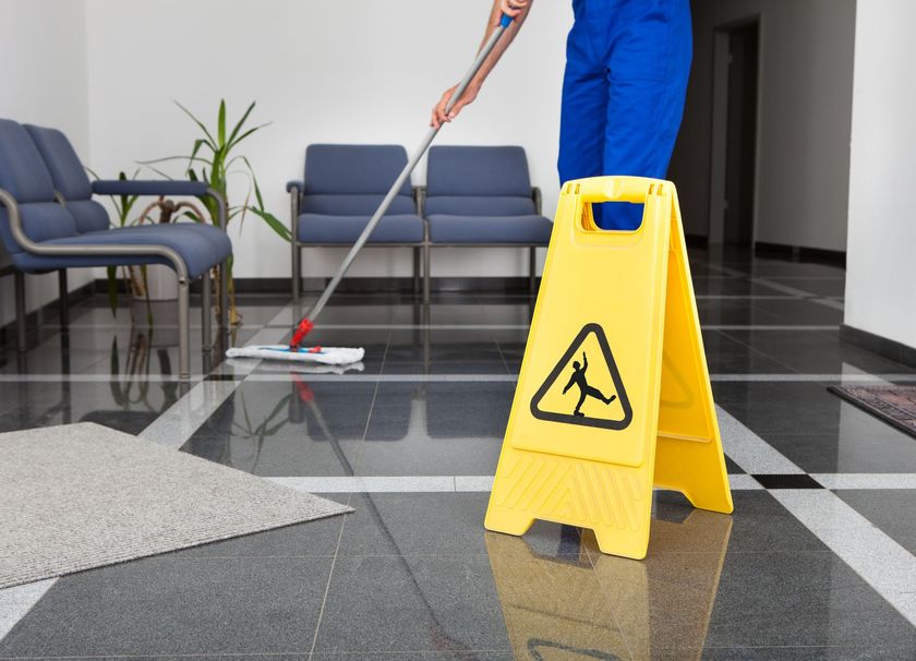 Man with mop and wet floor sign — Coeur D'Alene, ID — Mad Clean LLC