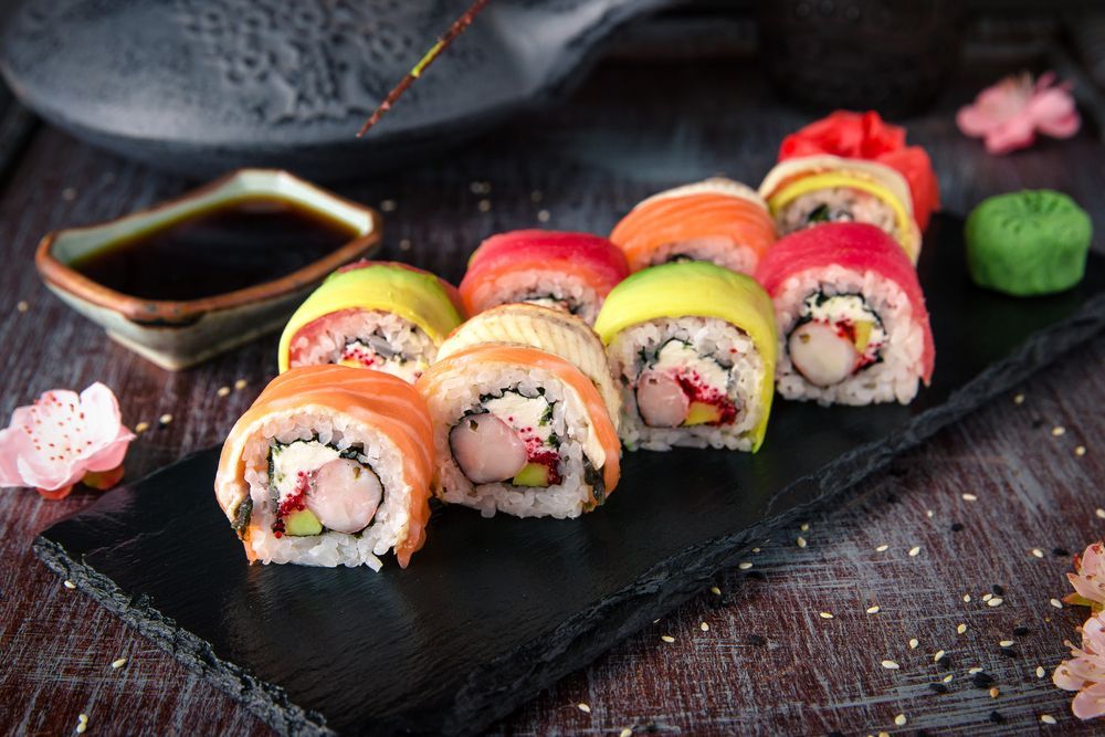 Rainbow Sushi Roll On A Black Plate — Swifty's Lismore Seafood Market In Lismore, NSW