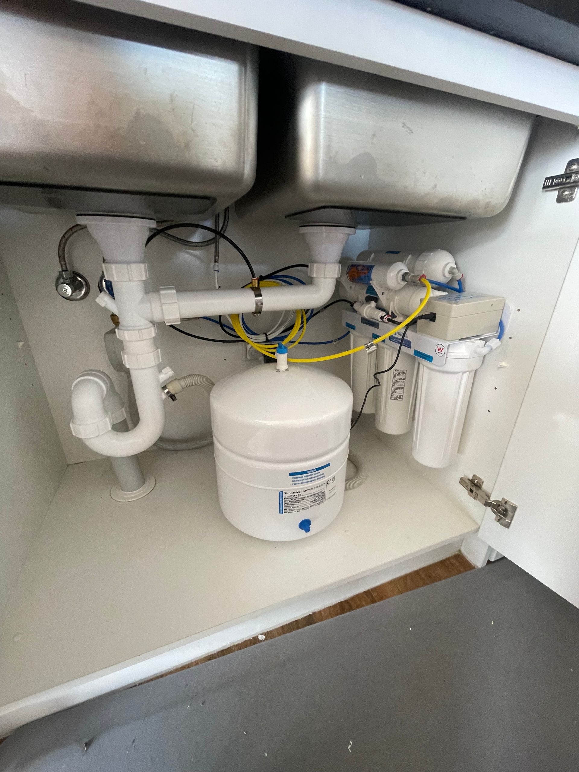A Kitchen Sink with A Water Filter Underneath It — Smooth Flow Plumbing Cairns in Cairns City, QLD 
