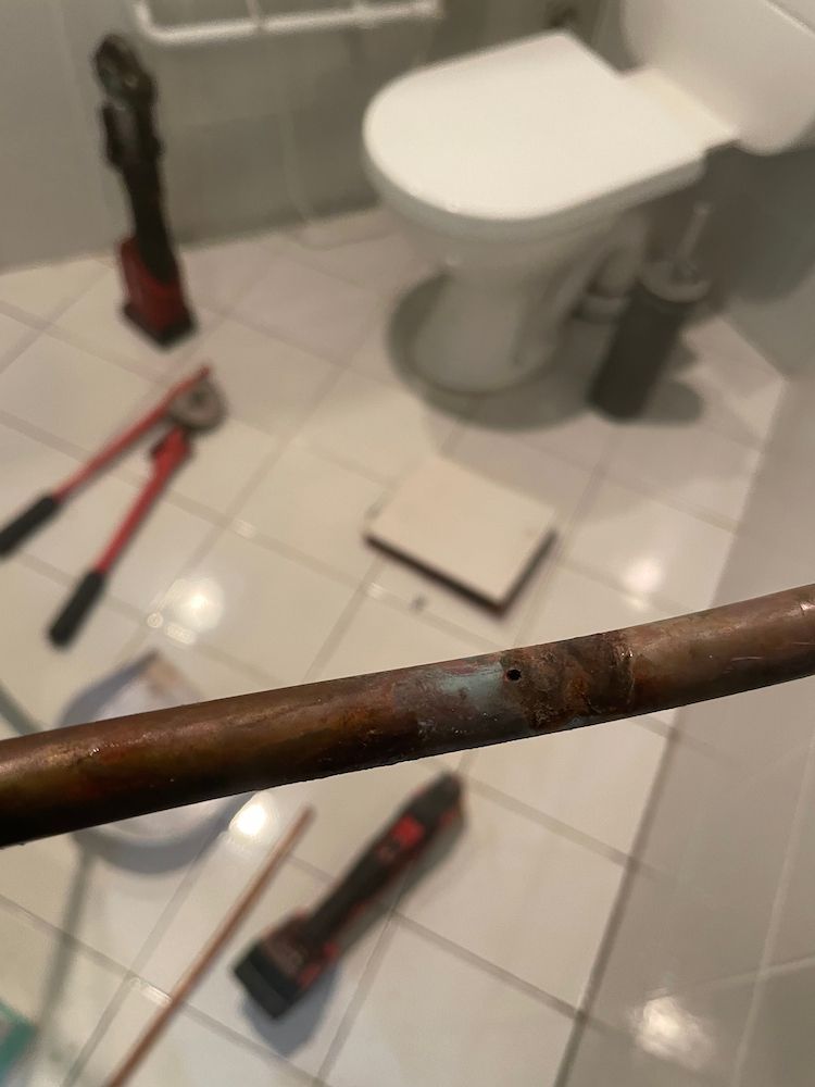 A Close Up of a Copper Pipe in a Bathroom Next to a Toilet — Smooth Flow Plumbing Cairns in Cairns City, QLD 
