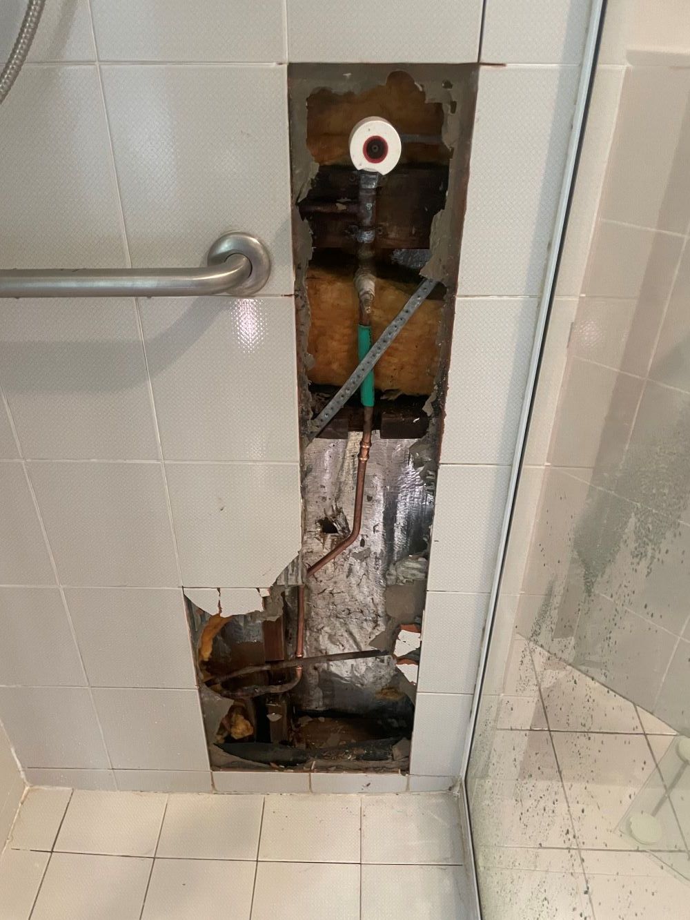 There is a Hole in the Wall in the Bathroom — Smooth Flow Plumbing Cairns in Cairns City, QLD