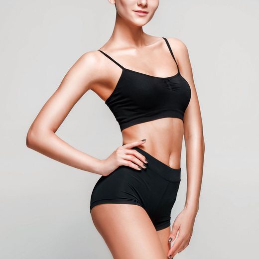 a woman is wearing a black bra and shorts