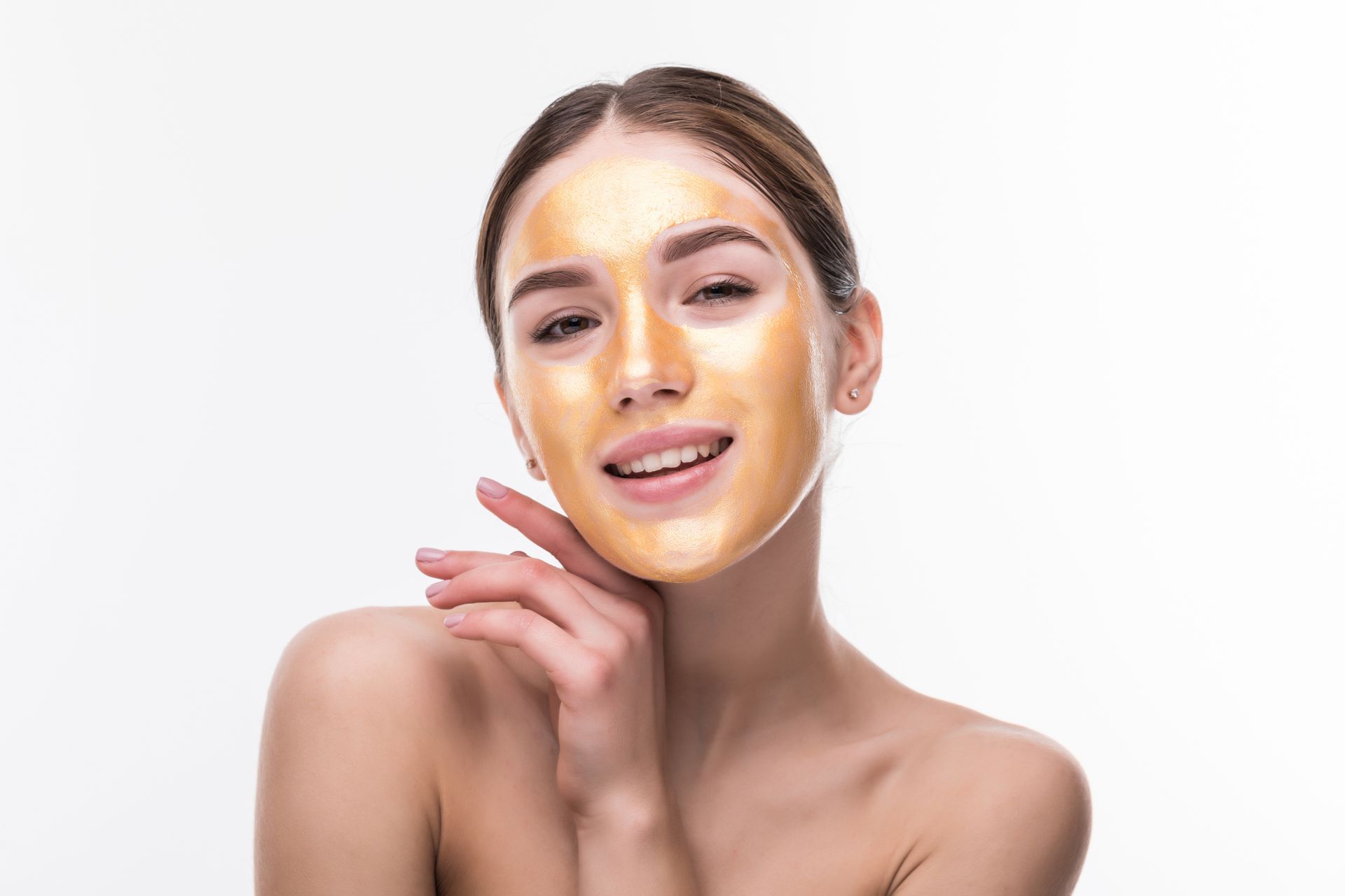 a woman is wearing a gold mask on her face