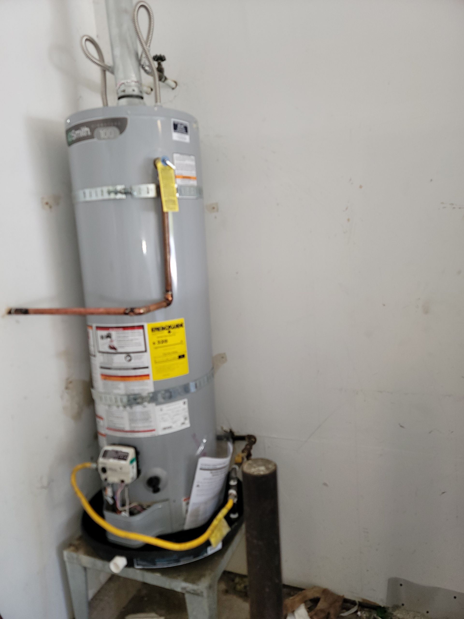 A plumber is fixing a sink in a kitchen.