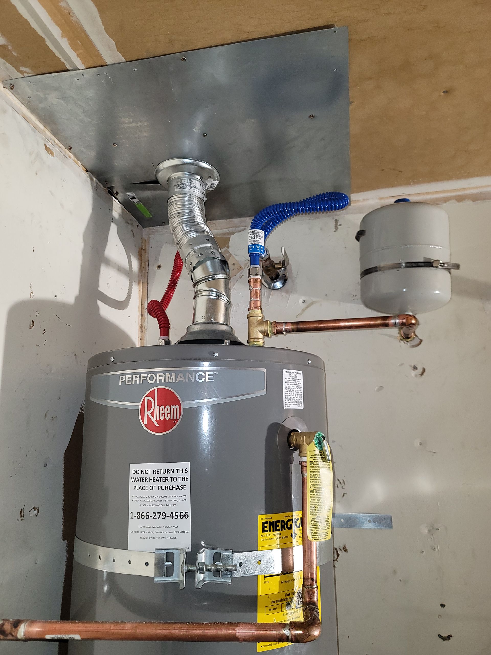 A man is fixing a sink in a kitchen.