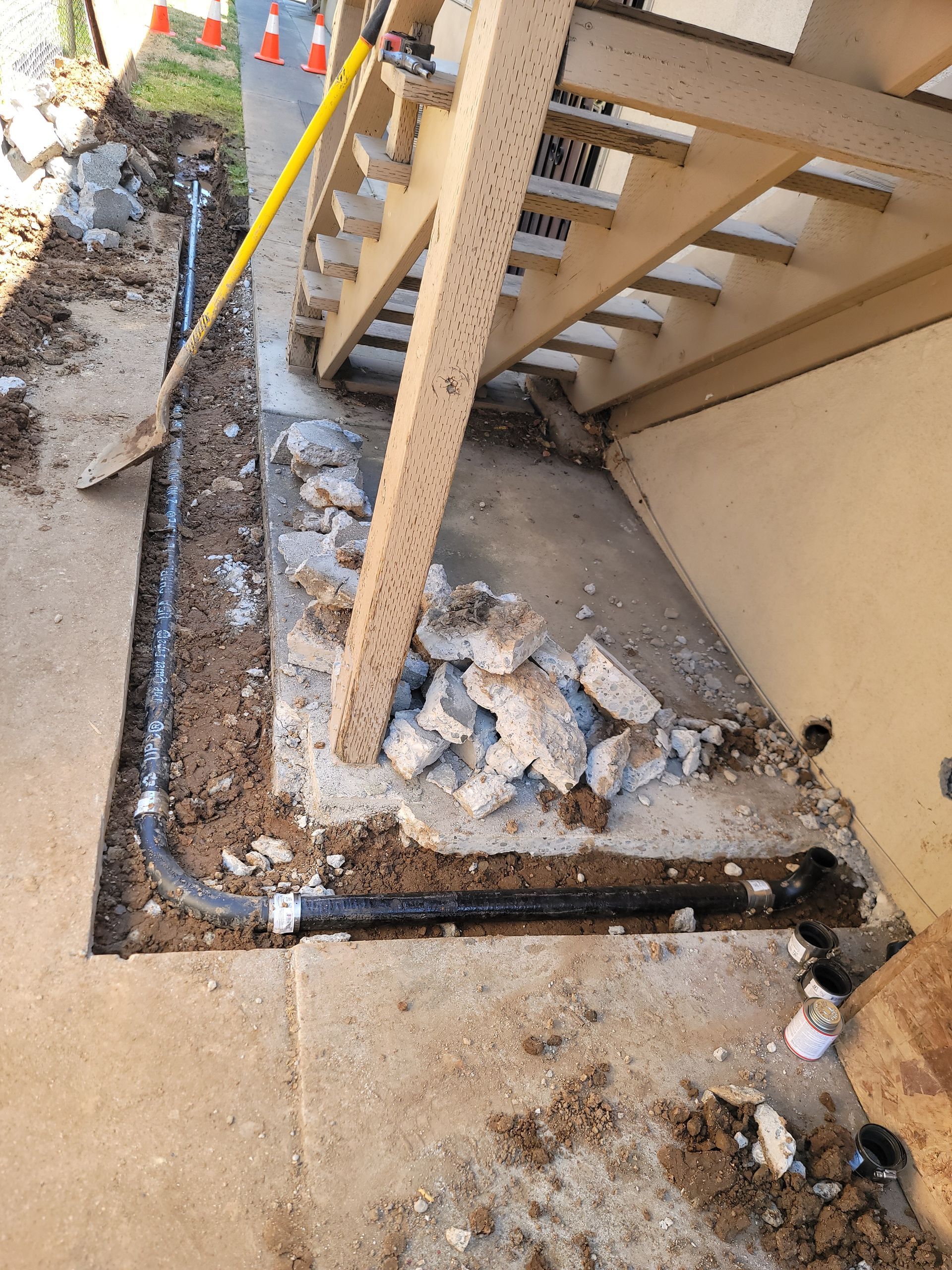 A man is working on a pipe system in a room.