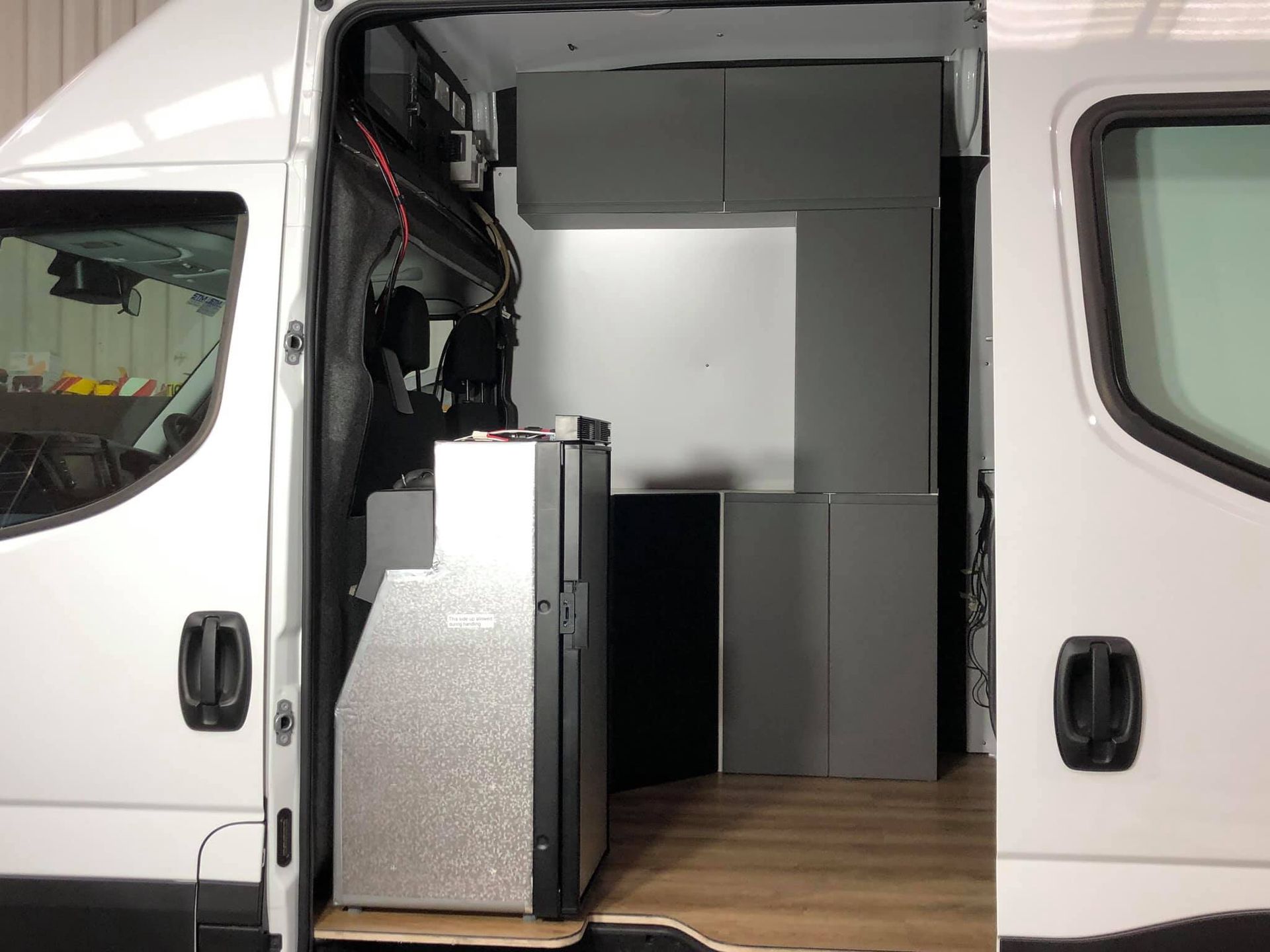 A White Van With the Door Open is Being Repaired — Truckserv In Yallah, NSW