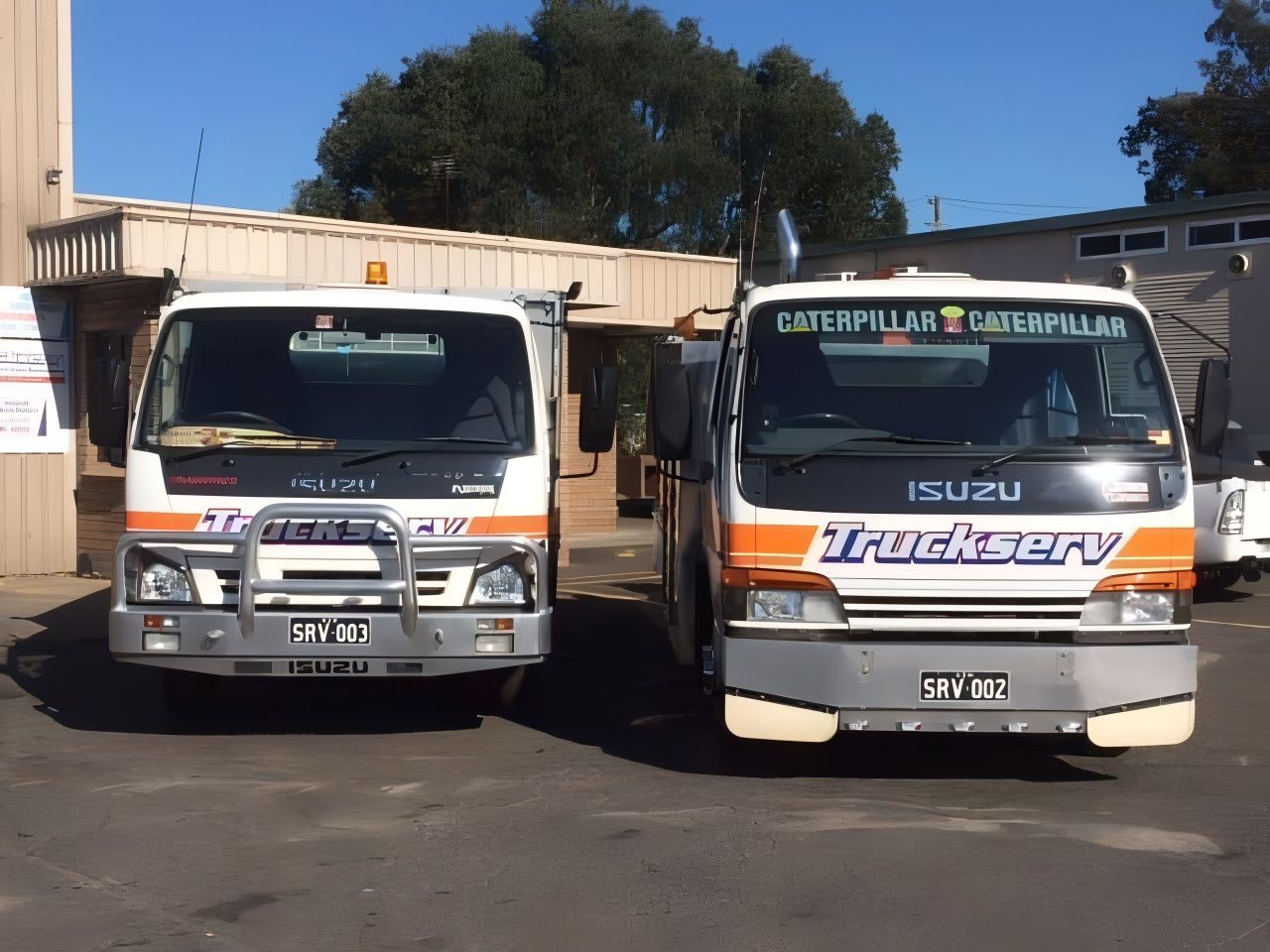 Two Isuzu Trucks Are Parked Next To Each Other — Truckserv In Yallah, NSW