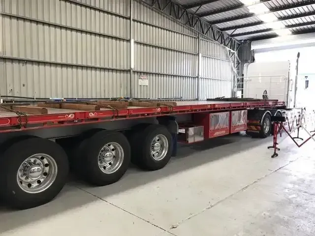 A Flatbed Truck is Parked in a Warehouse — Truckserv In Yallah, NSW