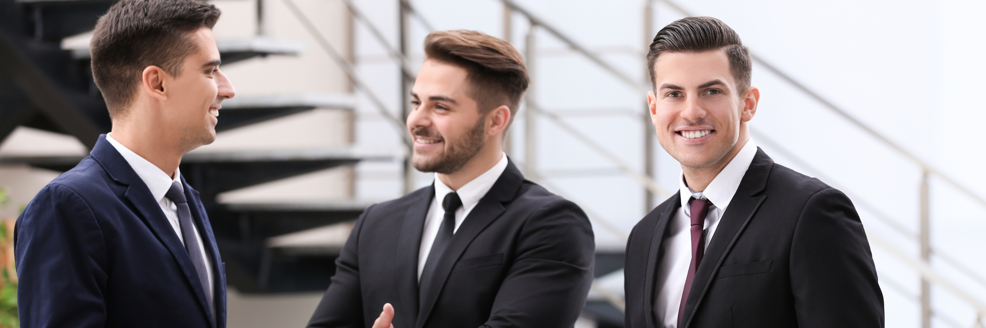 three young men in tailored suits