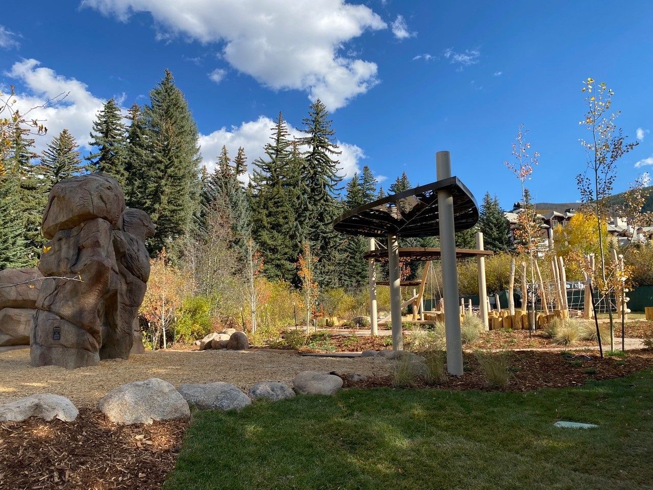 There is a large rock in the middle of the park.