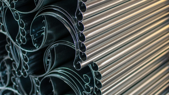 A close up of a stack of metal pipes.
