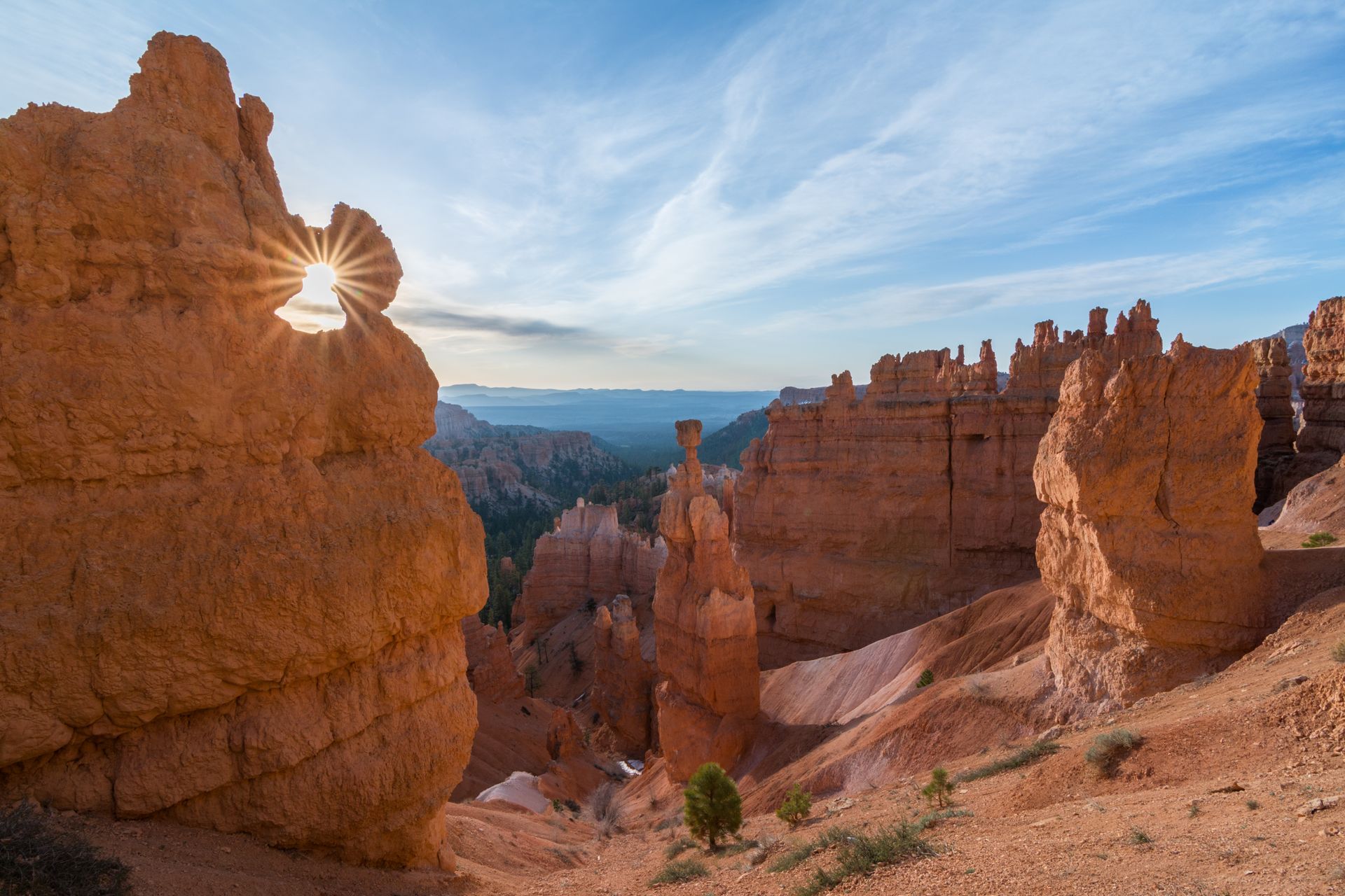 The sun is shining through the rocks in the canyon.