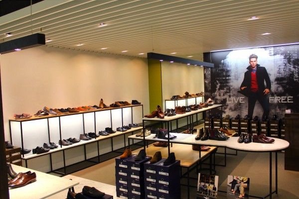 A shoe store with a picture of a man on the wall