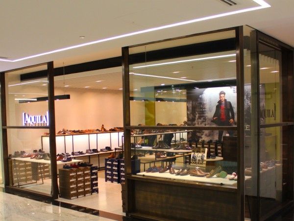 A shoe store with the word aquila on the front