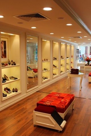 A shoe store with a red ottoman in the middle