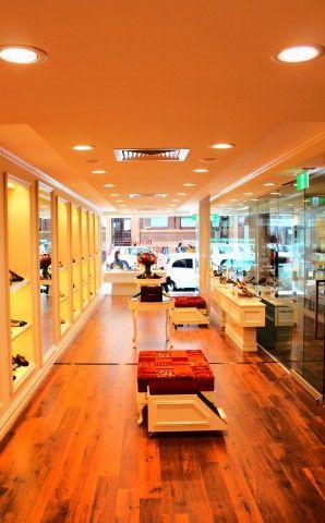 A long hallway in a shoe store with wooden floors
