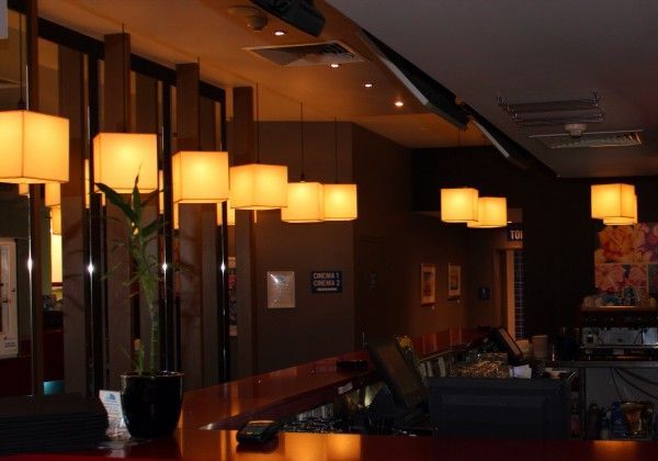 A restaurant with a lot of lights hanging from the ceiling