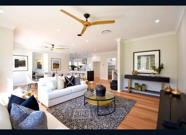 A living room with a white couch and a ceiling fan