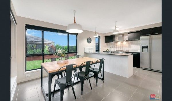 A kitchen with a table and chairs in it