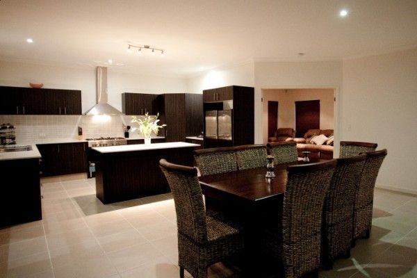 A kitchen with a table and chairs in it