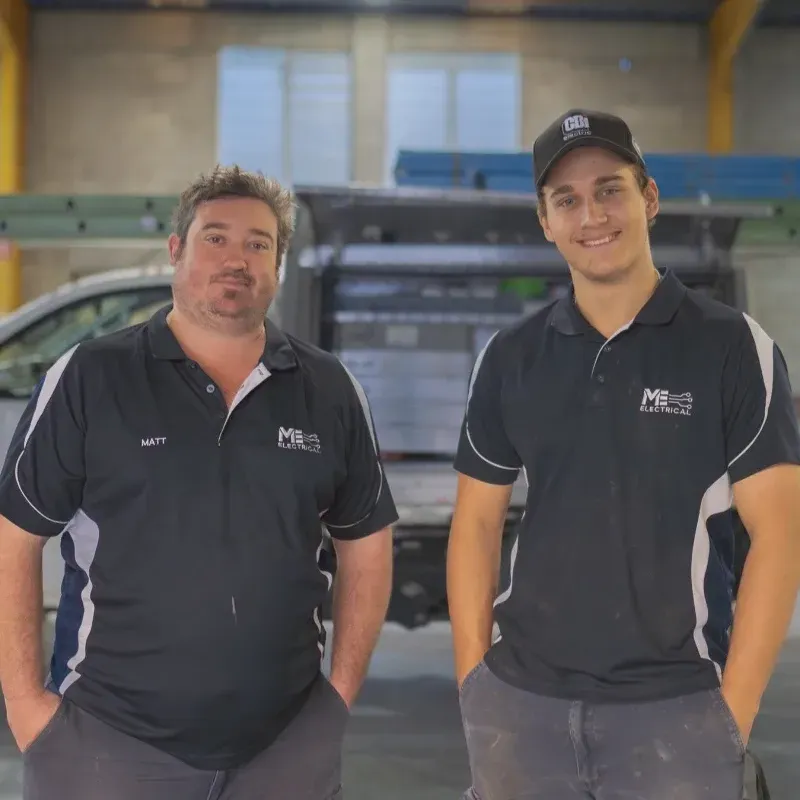Two electricians standing next to each other