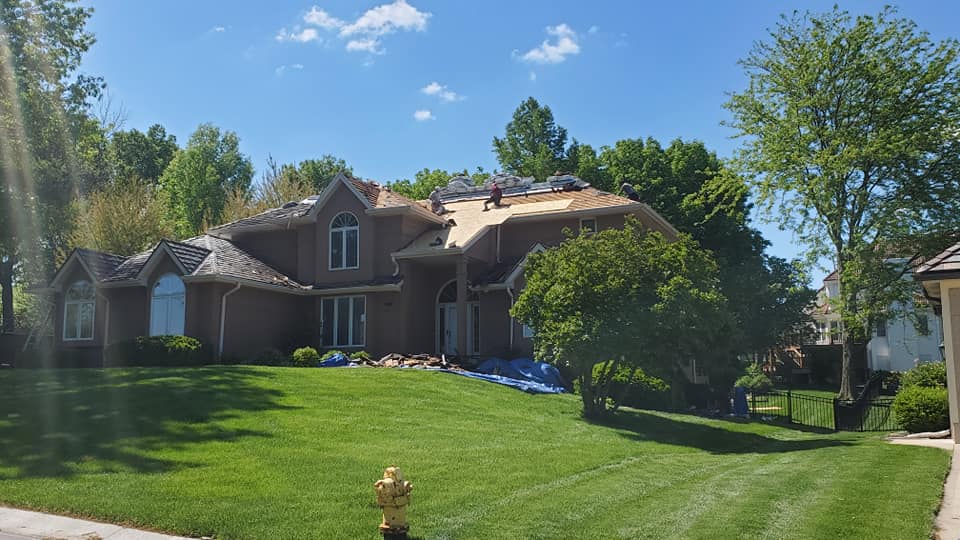Roofers on top of a house